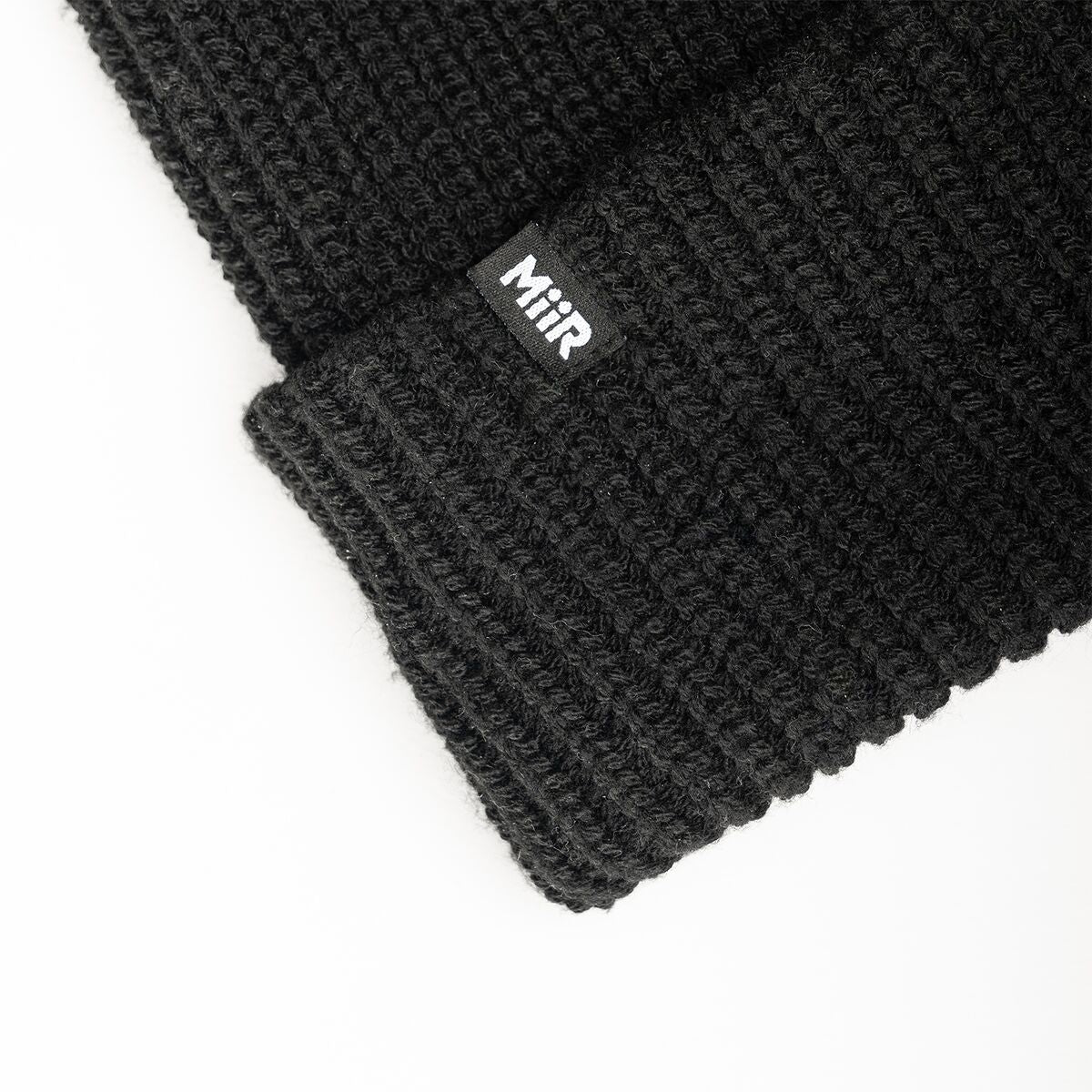 recycled-poly-rib-beanie-b0 WebPDP-RecycledPolyRibBeanie_Studio_TagDetail_Black__BNE002002OS.jpg
